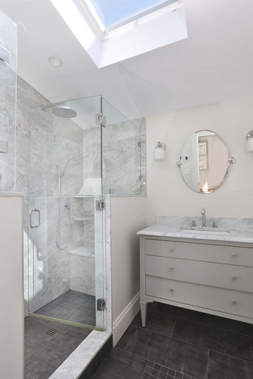 10 Beverly Road Newton, MA 02461 - Photo 11 of 19 a bathroom with a double vanity sink mirror and shower