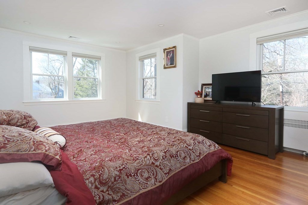 10 Beverly Road Newton, MA 02461 - Photo 10 of 19 a bedroom with a bed and a flat screen tv