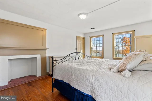 a bedroom with a bed and a fireplace