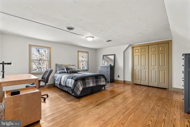 a spacious bedroom with a bed and a window