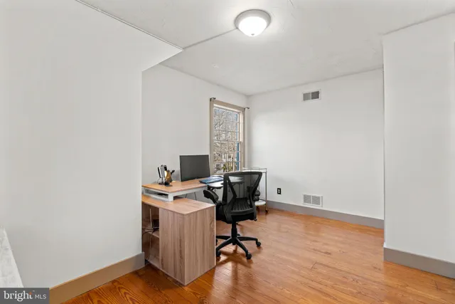 a view of workspace with wooden floor
