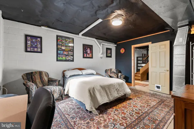 a bedroom with a bed and a mirror