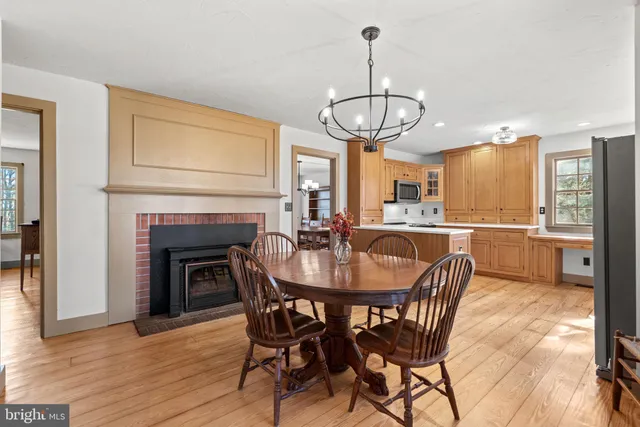 a view of a dining room with furniture wooden floor and chandelier