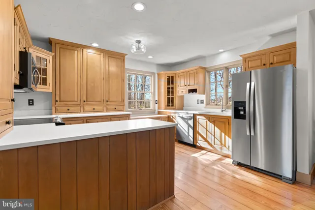 a kitchen with stainless steel appliances granite countertop a refrigerator and a sink