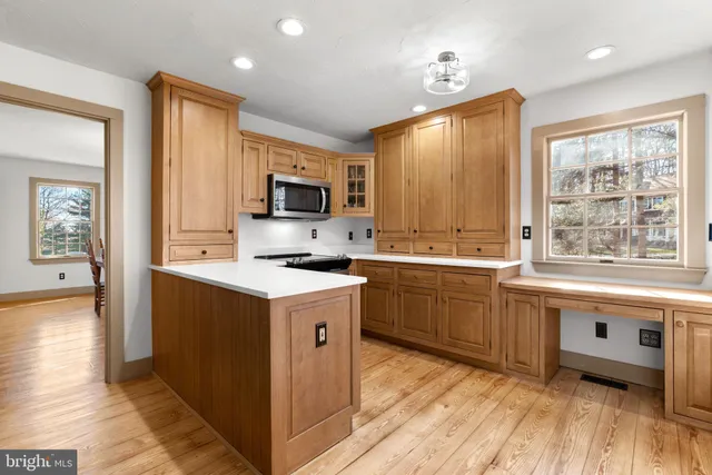 a kitchen with granite countertop a stove top oven sink and cabinets