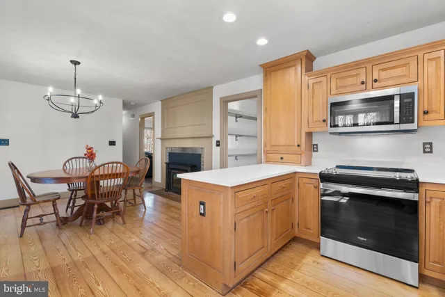 a open kitchen with a stove oven and a refrigerator