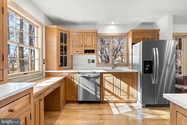 a kitchen with stainless steel appliances granite countertop a refrigerator and a sink