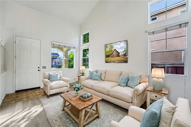 a living room with furniture a rug and a window