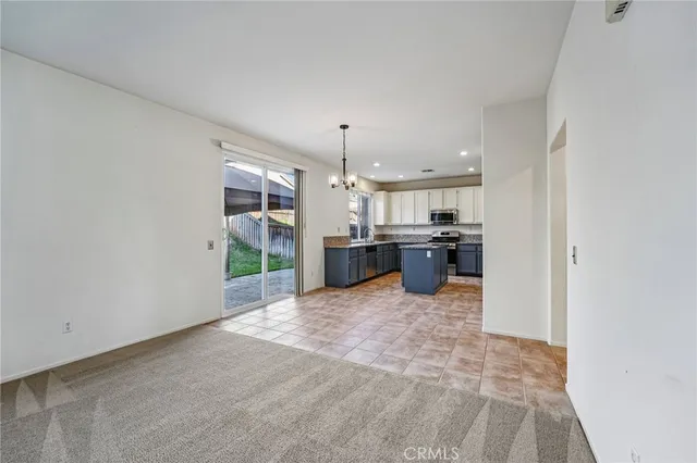 a view of kitchen with kitchen island sink and refrigerator