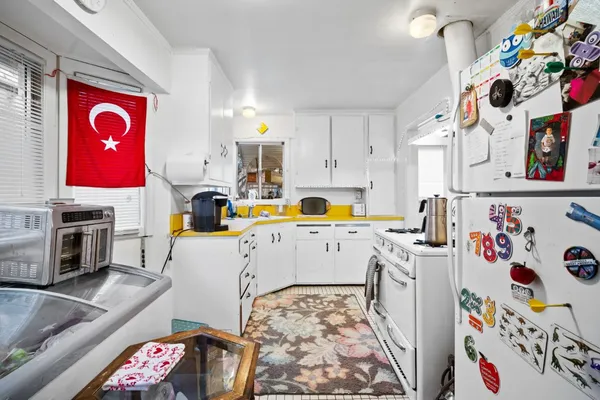 a kitchen with stainless steel appliances a stove a sink and a refrigerator