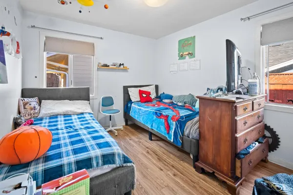 a bedroom with a bed a desk and chair