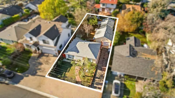 a view of a house with backyard porch and sitting area