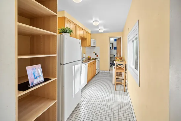 a kitchen with stainless steel appliances a stove a sink dishwasher and cabinets with wooden floor