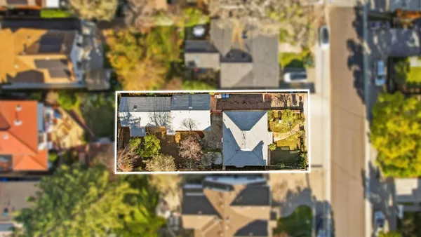 an aerial view of a house with a tree