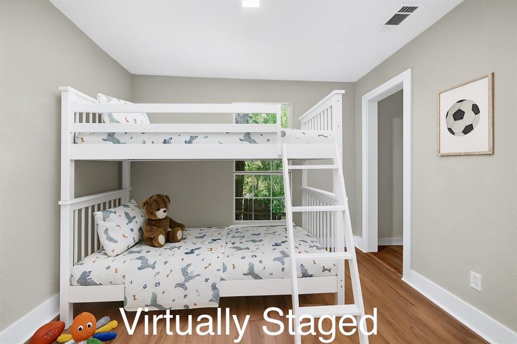 205 West Bond Street Denison, TX 75020 - Photo 11 of 23 Bedroom 3 featuring baseboards and wood finished floors