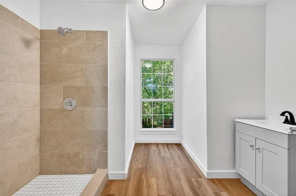 a bathroom with a sink and glass door