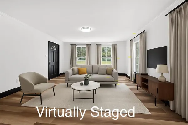 a living room with furniture and a flat screen tv