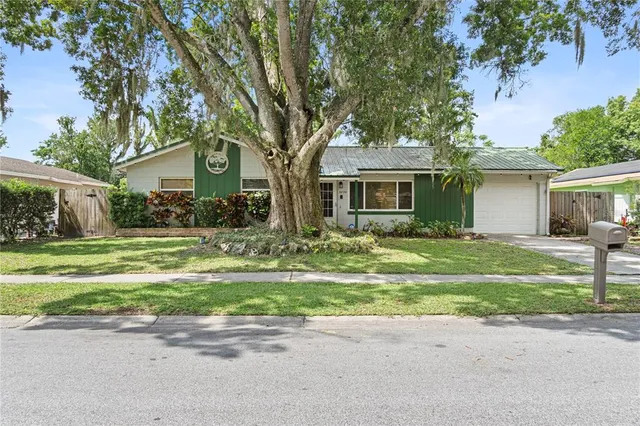 a front view of house with yard and green space