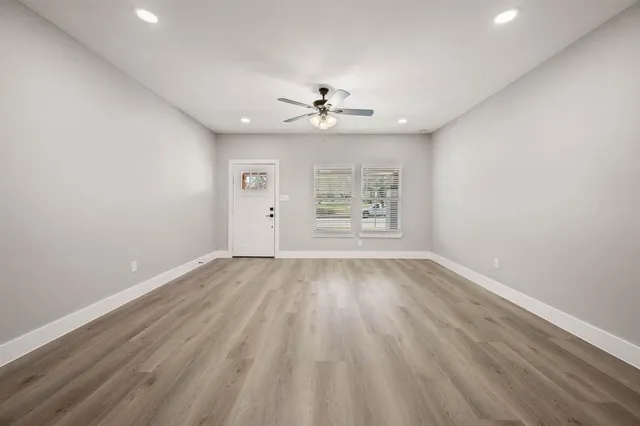wooden floor in an empty room with a window