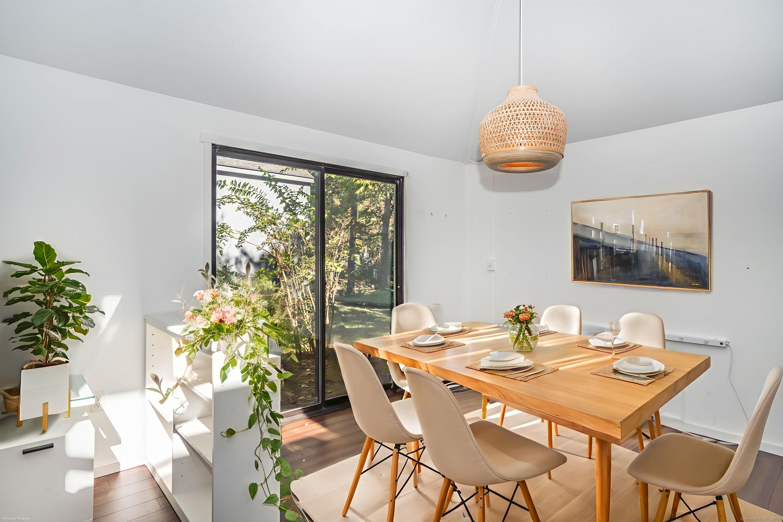 1 Morningside Court, Unit 1 Avon, CT 06001 - Photo 11 of 31 a dining room with furniture a large window and potted plants