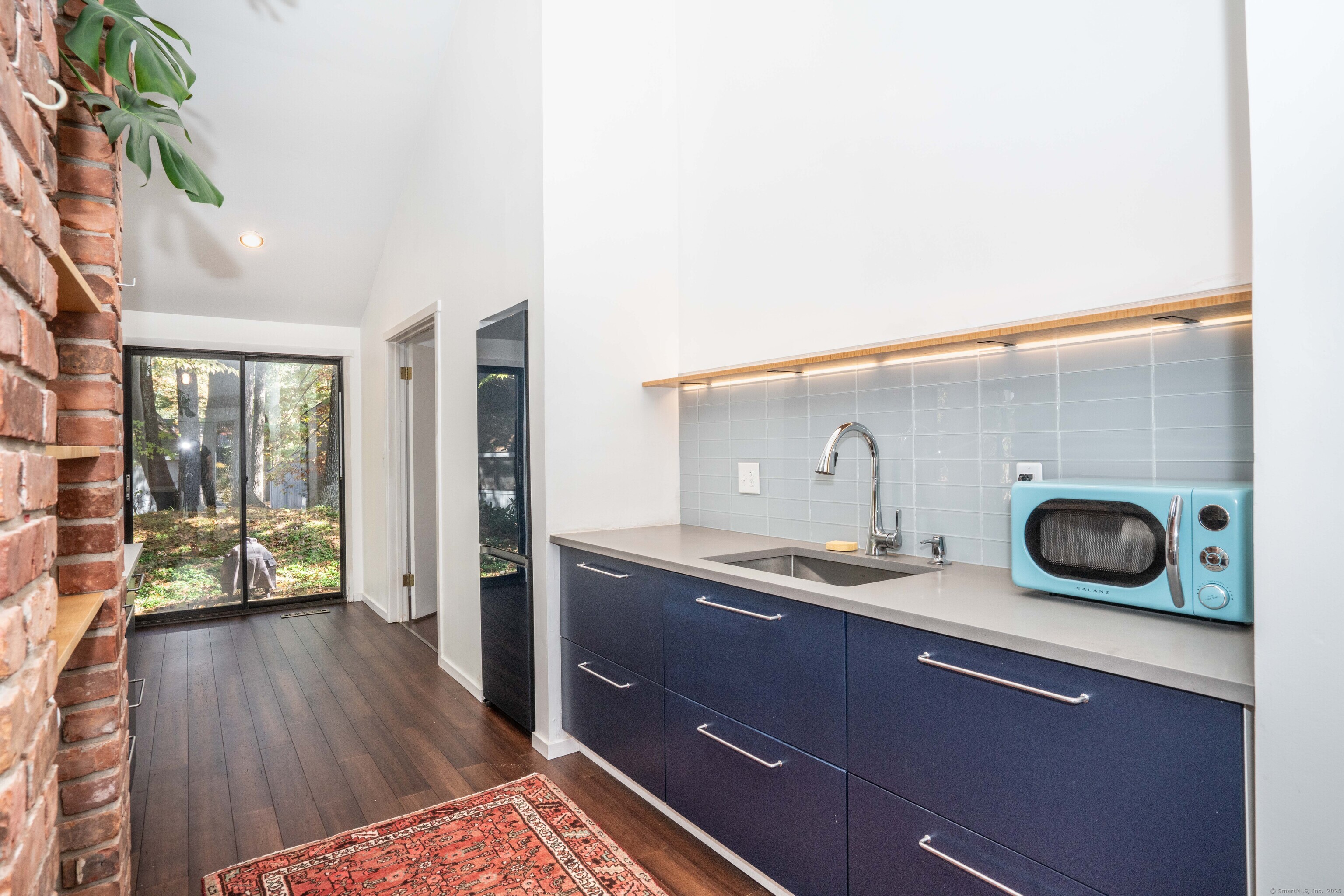 1 Morningside Court, Unit 1 Avon, CT 06001 - Photo 6 of 31 a kitchen with a wooden floor and a sink