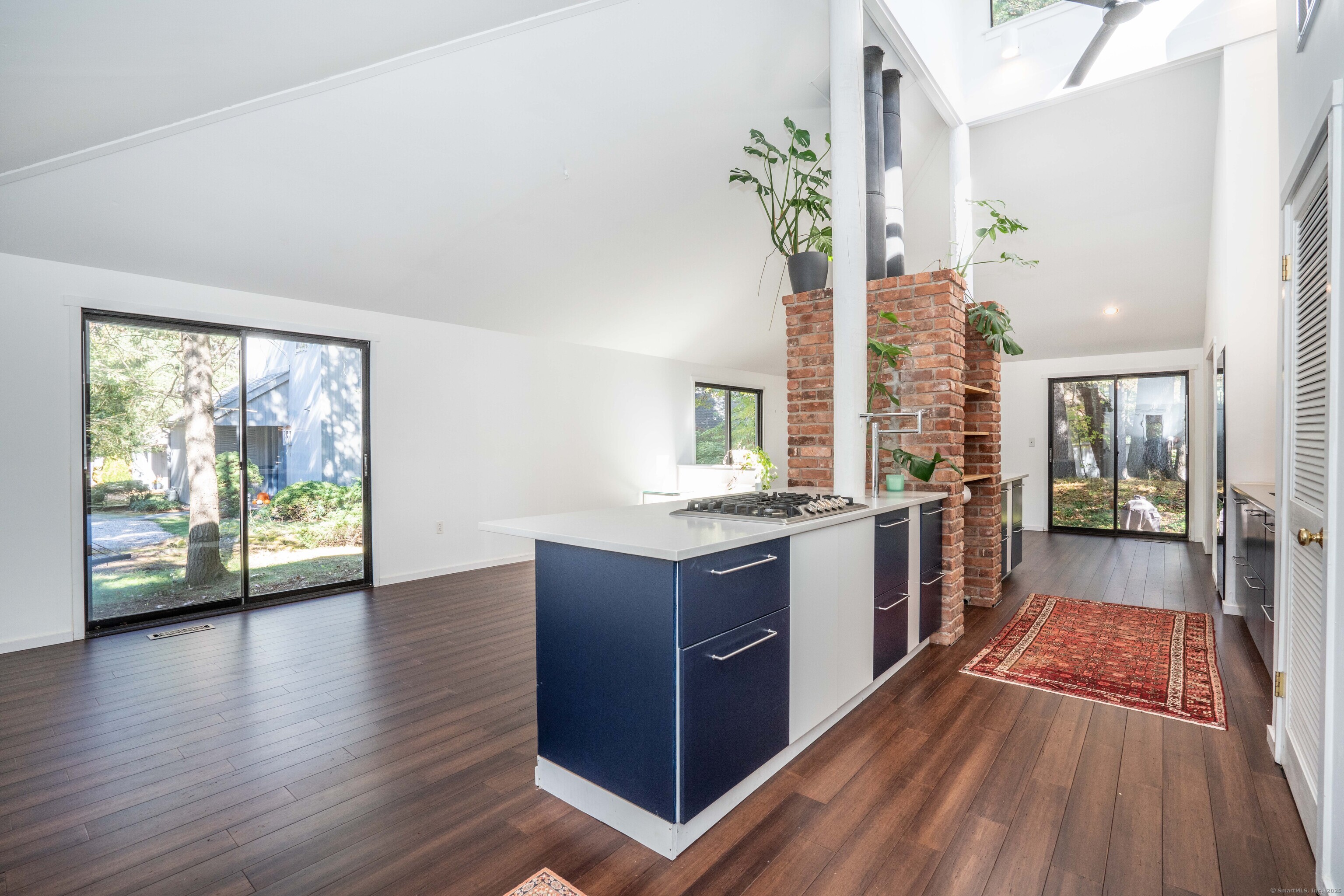 1 Morningside Court, Unit 1 Avon, CT 06001 - Photo 7 of 31 a large kitchen with granite countertop a large counter top space wooden floor and stainless steel appliances