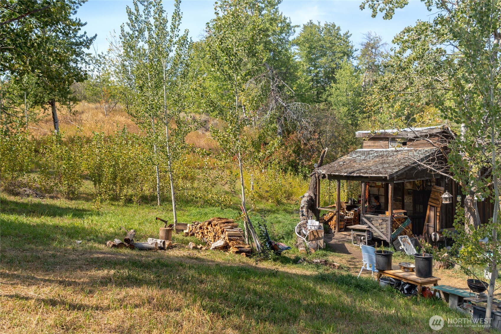 653 B Ellemeham Mountain Road Oroville, WA 98844 - Photo 17 of 33 a view of a patio with table and chairs under an umbrella