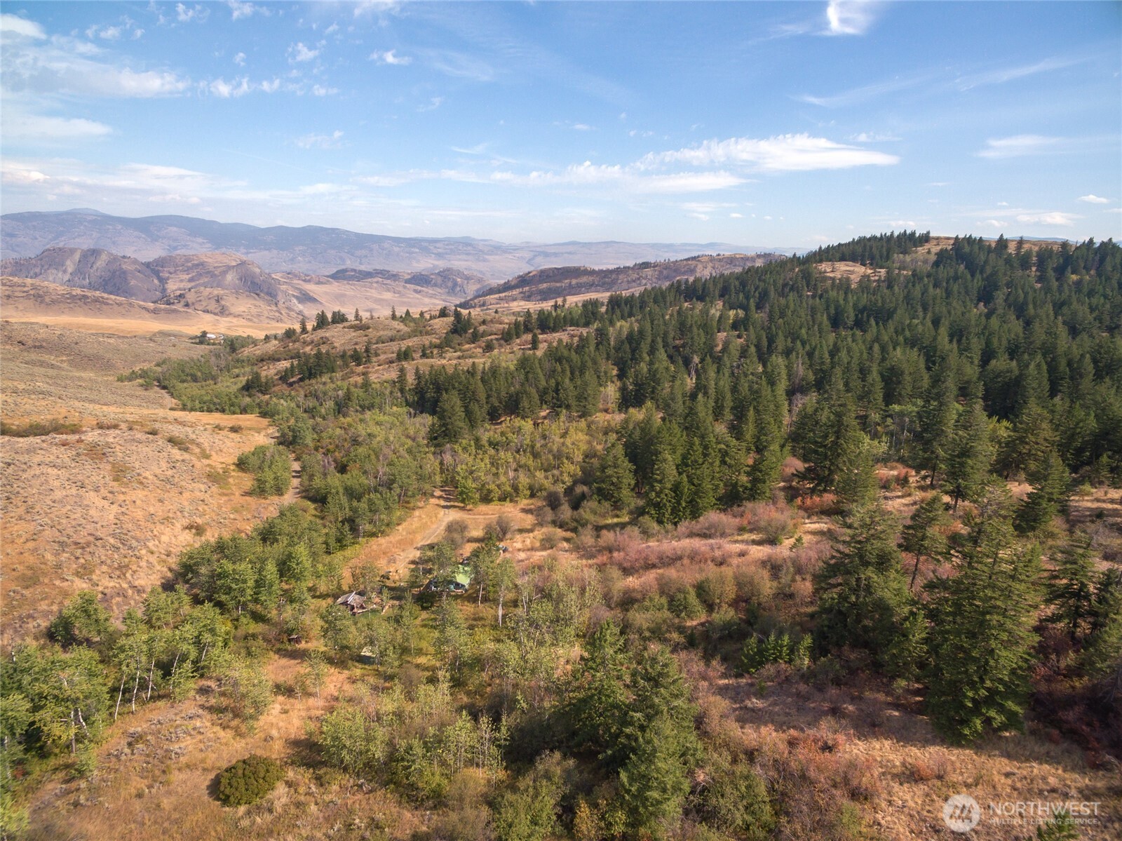 653 B Ellemeham Mountain Road Oroville, WA 98844 - Photo 23 of 33 a view of a city with mountains in the background