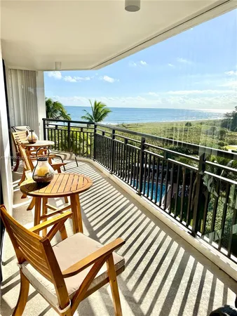a balcony with table and chairs