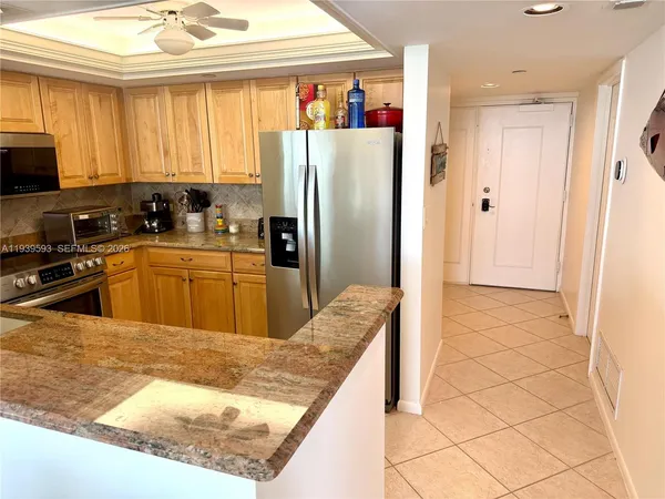 a kitchen with stainless steel appliances granite countertop a refrigerator and a sink