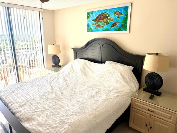 a bedroom with a bed and a painting on the wall