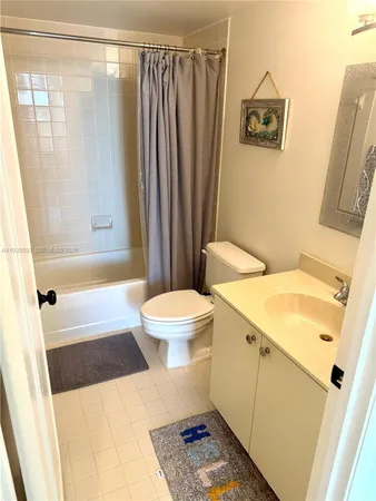 a bathroom with a sink a toilet a mirror and shower