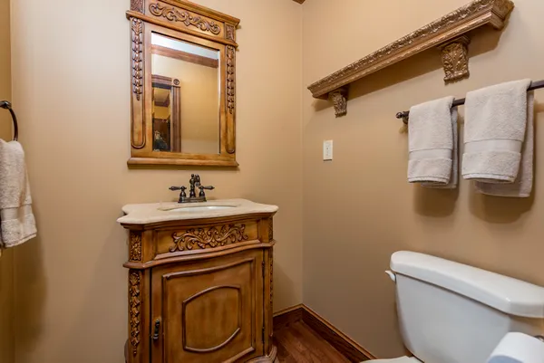 a bathroom with a toilet a sink and mirror
