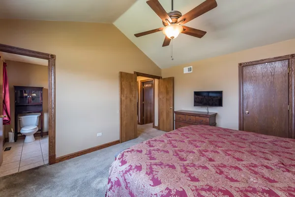 a bedroom with a bed and a television