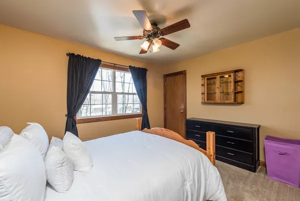 a bedroom with a bed and a chandelier