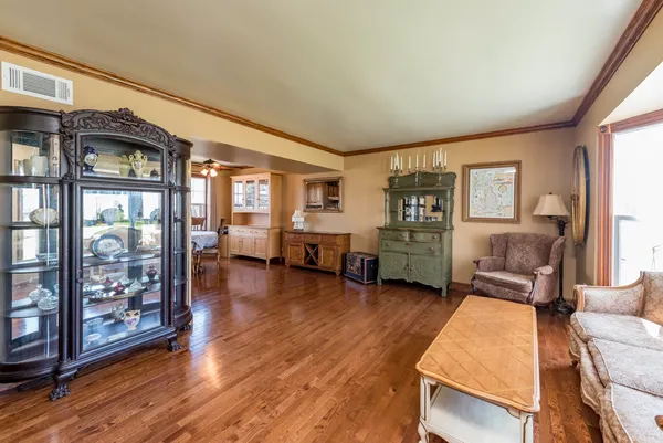 a living room with furniture and wooden floor