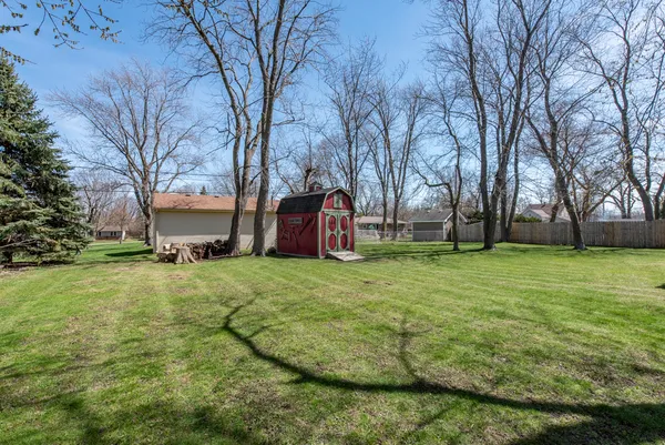 a view of a backyard with large trees