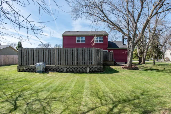 a view of a house with a yard and a fence