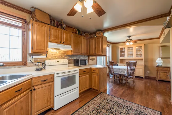 a kitchen with a sink window and cabinets