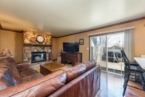 a living room with furniture a flat screen tv and a fireplace