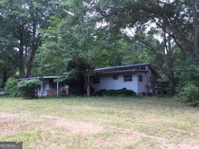 111 Mitchell Road Fayetteville, GA 30214 - Photo 9 of 19 a view of a couches in front of a house with large trees