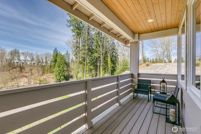 a view of a city from a balcony with furniture