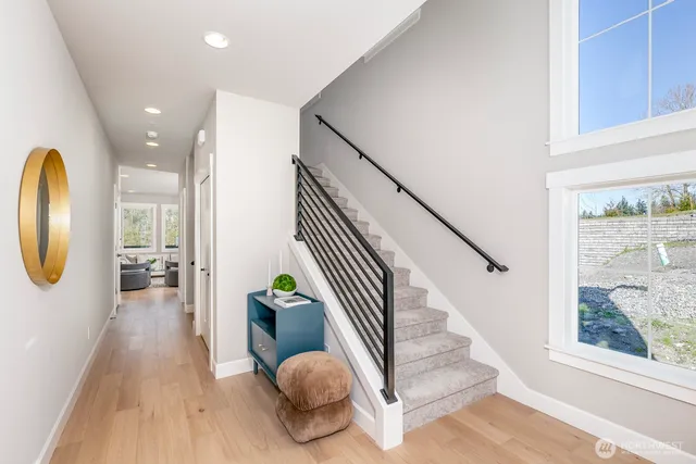 a view of entryway and hall with wooden floor