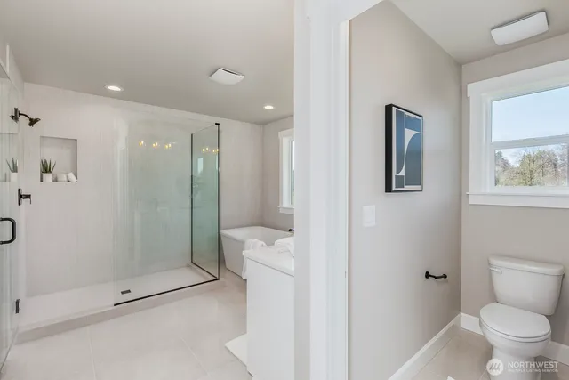 a bathroom with a shower a toilet and a sink