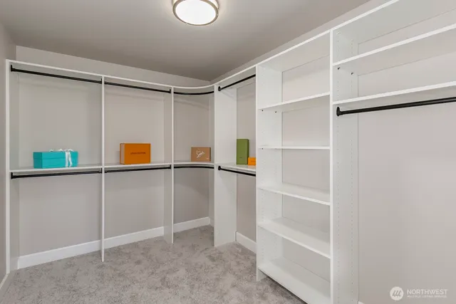 a view of walk in closet with empty racks