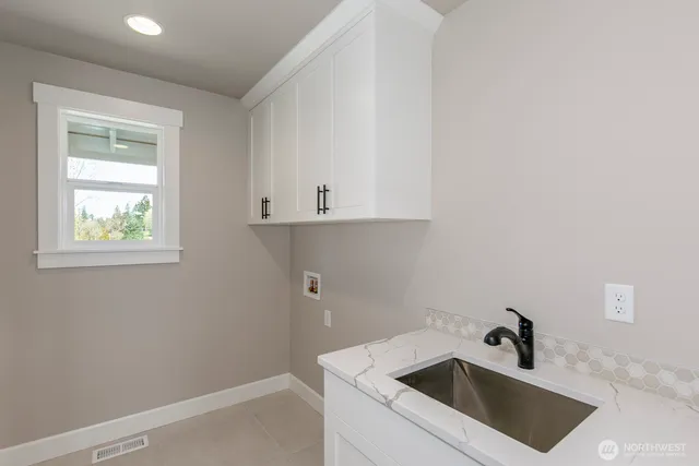 a bathroom with a sink and cabinets