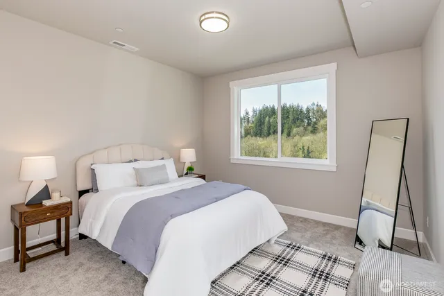 a bedroom with a bed and a mirror