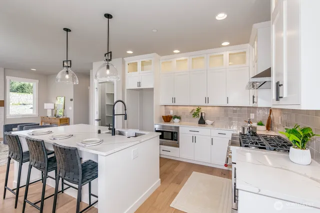 a kitchen with a white center island and cabinets