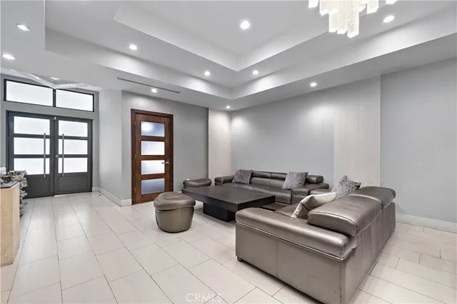 a living room with furniture a window and a chandelier