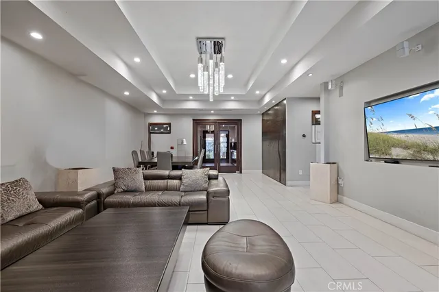 a living room with furniture and a chandelier